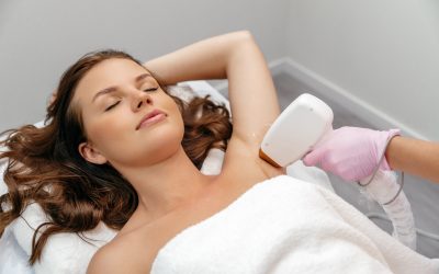 Beauty procedure. Hair removal by laser hair removal. Caucasian young woman lies on the couch with Beauty procedure. Hair removal by laser hair removal. Caucasian young woman lies on the couch with