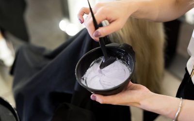 paint with a brush in the hands of a hairdresser paint with a brush in the hands of a hairdresser